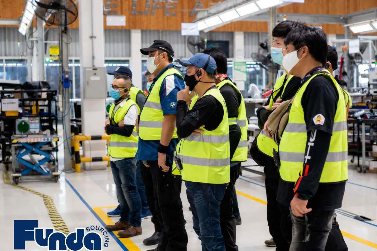 Factory team reviewing production lines during a supplier visit